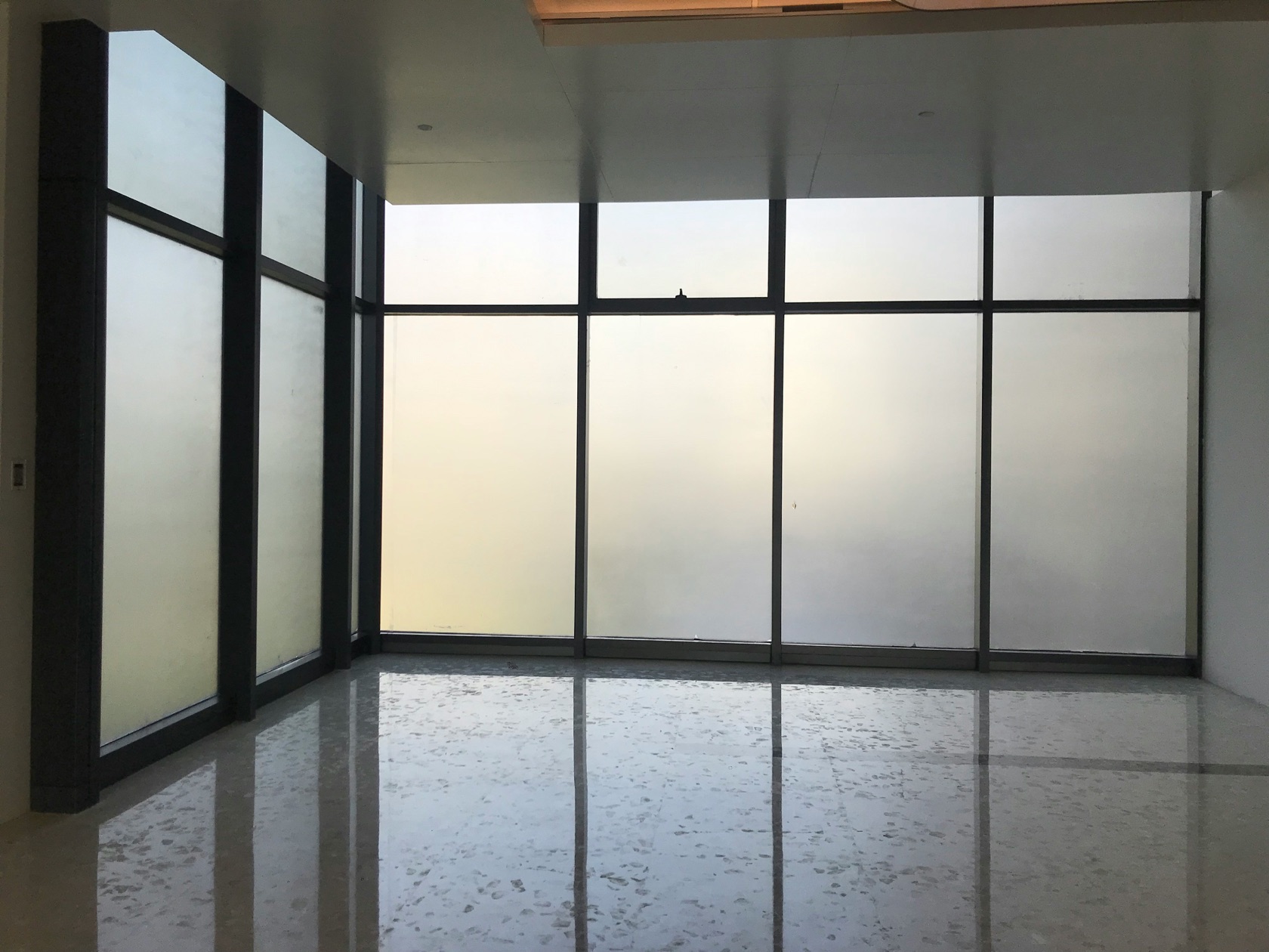 Installer applying solar control window film in a commercial office