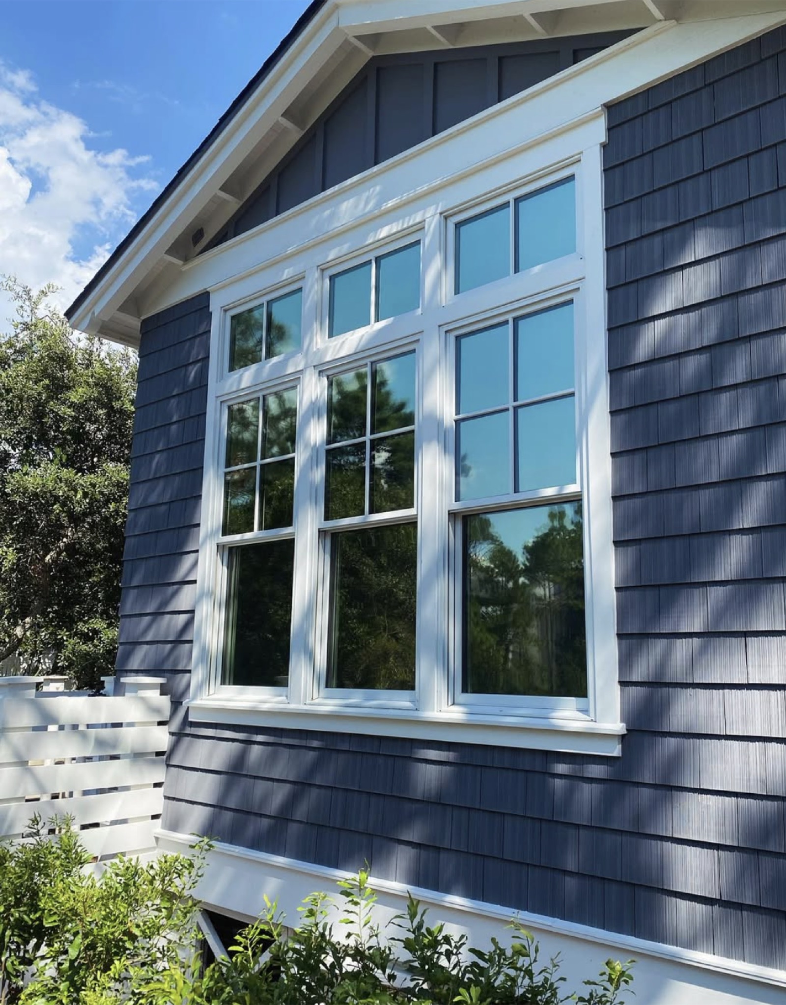 Upscale blue coastal home with tinted windows near Rosemary Beach, FL
