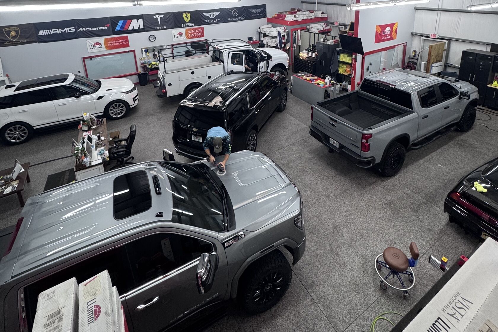 Exzact shop floor full of trucks and SUVs in for window tinting, Panama City Beach, FL